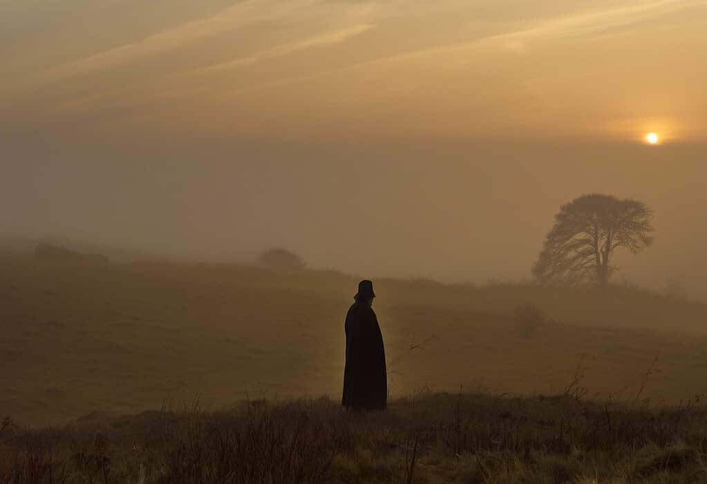 Misty morning on Egdon Heath with a lone figure overlooking the heath